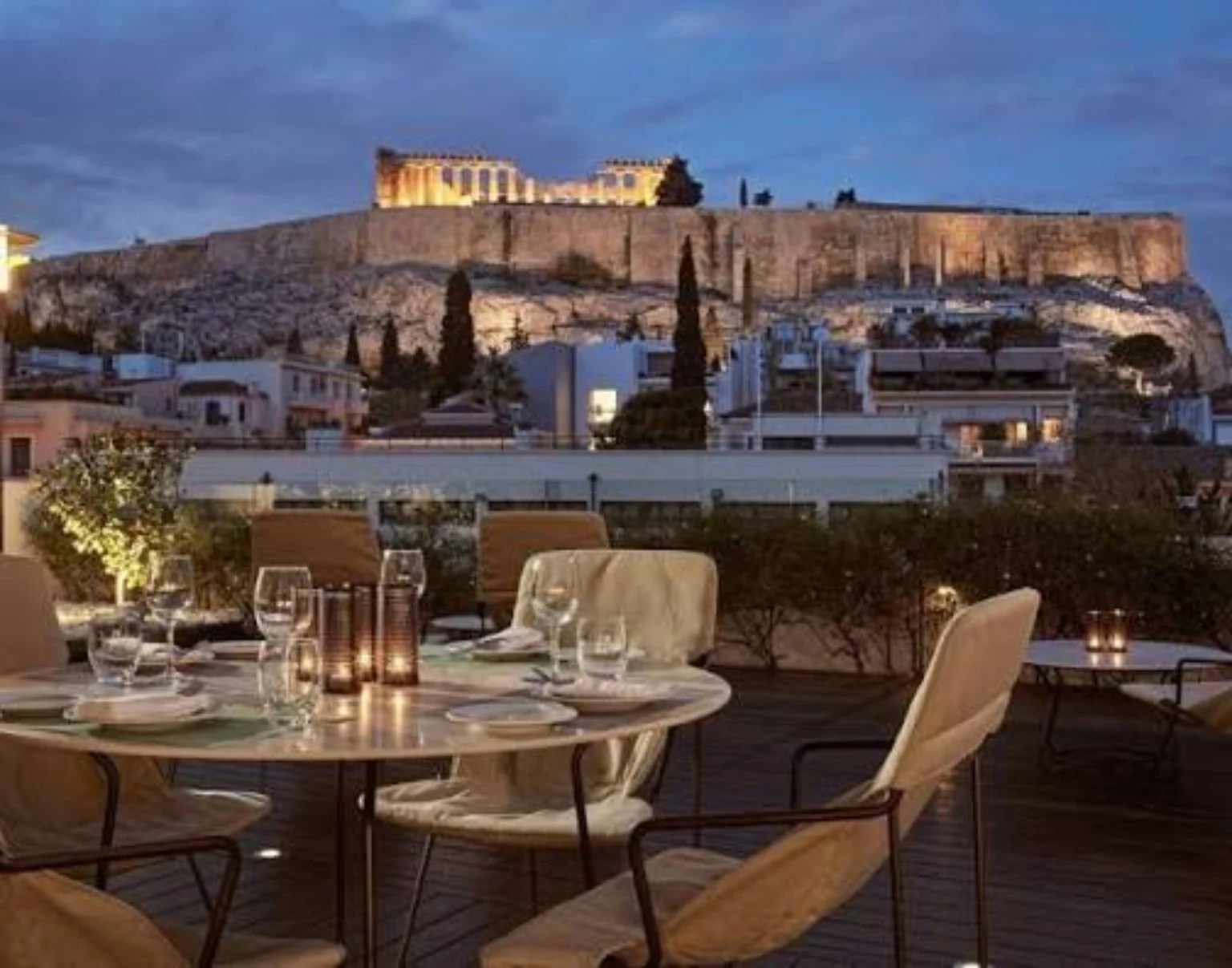 Athens rooftop terrace overlooking the illuminated Acropolis
